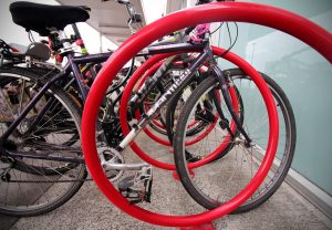 Bikes parked at a red spiral bike rack